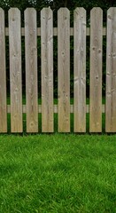Fototapeta premium Lush green grass and a wooden fence providing a peaceful, natural outdoor background setting perfect for spring or summer scenes ,garden ,peaceful ,grass