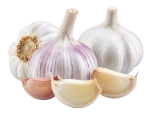 Three garlic bulbs and four loose cloves on a dark background, illuminated by bright light