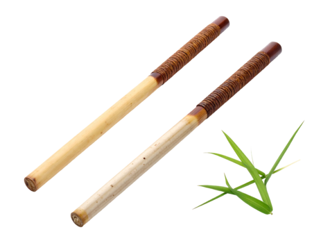 Two bamboo sticks with brown ends, and green grass, isolated on a black background, angled slightly