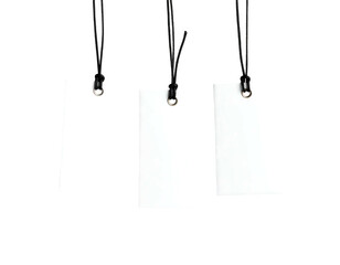 Three blank white tags hang from black cords, against a stark black background creating high contrast