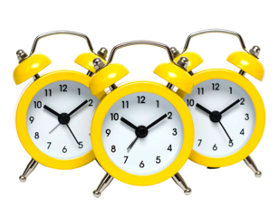Three bright yellow alarm clocks grouped together, on a black background, showing different times