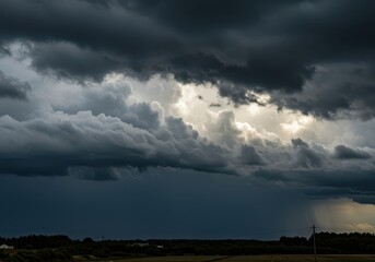 Obraz premium Dramatic view of a massive, dark cloudscape covering the entire sky, signaling an imminent heavy thunderstorm and downpour of rain ,vast ,sky ,dramatic