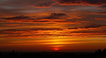 Obraz premium Spectacular sunset background featuring deep orange and amber tones illuminating expansive, wispy stratocumulus clouds in the vast heavens ,evening ,background ,atmospheric