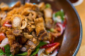 Fried pieces of pork for crispy skin topping on Thai salad