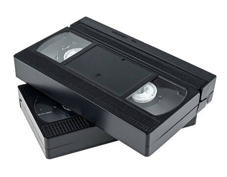 Two black VHS tapes stacked slightly angled against a black backdrop, showcasing their rectangular shapes