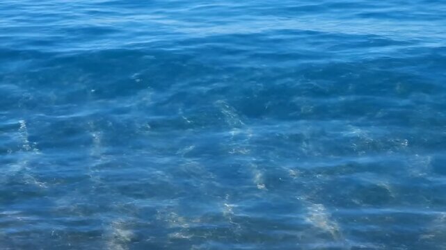 Abstract shimmering patterns of sunlight reflecting and dancing on the surface of calm, clear blue water, creating a mesmerizing natural backdrop patterns, pool, oceanic