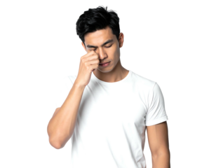 Man in white shirt rubs his eye, looking tired or stressed against a plain, dark background