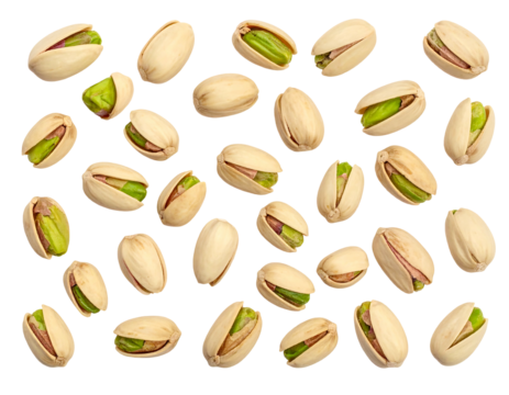 Pistachios scatter across a black backdrop, their shells cracked, revealing vibrant green nuts inside, creating a pattern