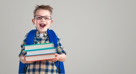 Happy young school boy child with backpack.