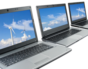 Three laptops display varying skyscapes, lined up and angled to the right with silver keyboards and black frames