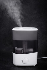 Air Humidifier with Steam on Black Background