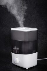 Air Humidifier with Steam on Black Background