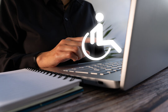 A woman working on her laptop while pointing at a disabled icon