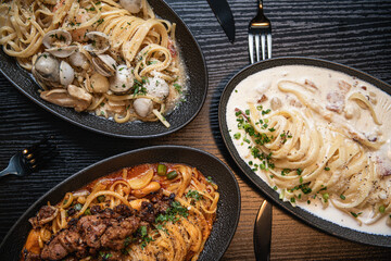 Assortment of Gourmet Pasta Dishes on a Dark Table