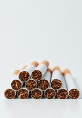 A cluster of unlit filter cigarettes arranged horizontally, emphasizing the harmful nicotine and tobacco content against a clean white backdrop ,unlit ,nicotine ,danger
