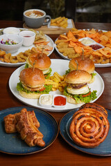 Snack Platter, captured on October 24, 2025. Crispy fries, onion rings, nuggets, and sauces served on a wooden board, tasty assortment perfect for sharing and casual dining visuals
