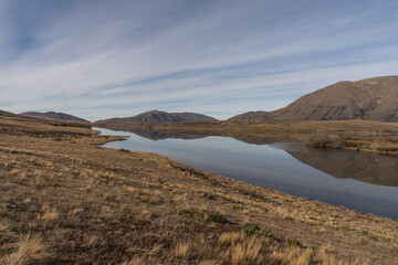 Views of alpine tussock land and mountains on  shore of Lake Clearwater from the circuit track around the lake