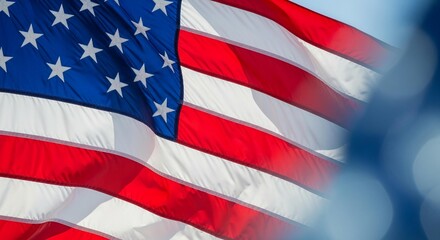 Obraz premium Stunning American flag gracefully waving in the breeze, a powerful symbol of freedom and national pride against a clear blue sky.