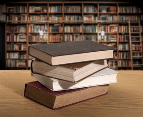 Old books set on wooden shelf.