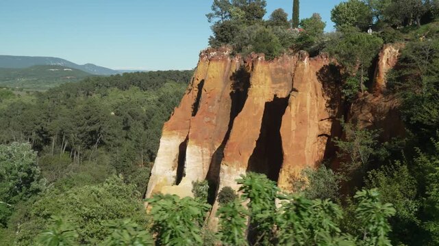 Aerial shot of Roussillon, where colorful ochre cliffs meet the calm charm of southern France.