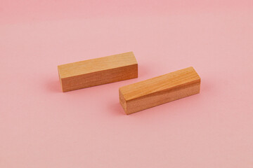 Simple wooden blocks on pink background for creative projects