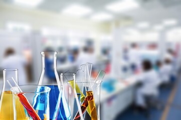 Scientist light colored liquid in flask in laboratory,