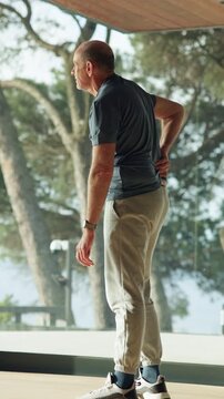 Back pain, physiotherapy and physiotherapist with patient in office for exercise, checkup or help. Service, injury and physical therapist with man for spinal rehabilitation for healing in clinic.