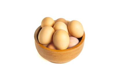 Chicken eggs on the wooden bowl. Isolated eggs on white background