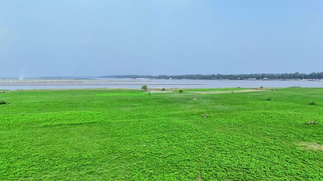 Aerial view of lush green riverside landscape along the Jamuna River in Bangladesh