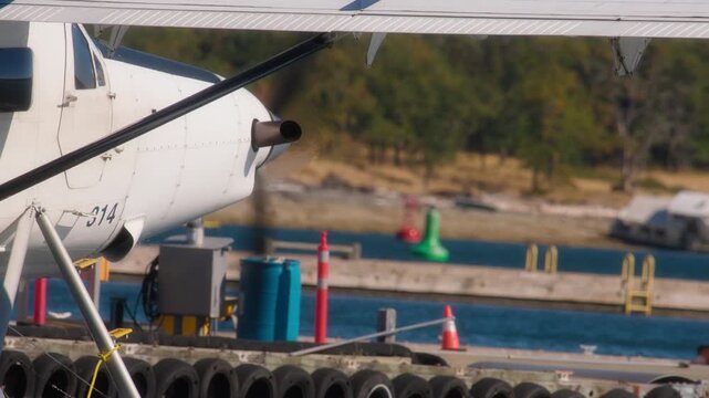 Close up of a seaplane gliding on water near the harbour dock