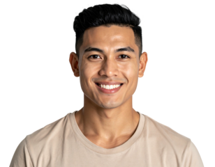 Smiling young man with dark hair and tan skin, wearing a light beige shirt, against a dark background