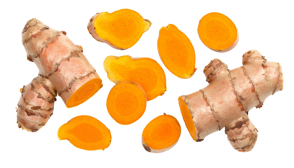 Two whole turmeric rhizomes with several bright orange, sliced cross-sections scattered across a black background