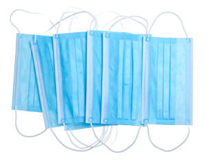 Stacked light blue surgical masks isolated on black. Protective gear with white elastic ear loops