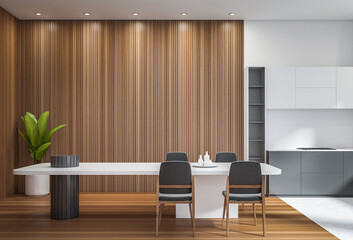 Contemporary dining room and kitchen interior with wooden slat wall, minimalist furniture, gray chairs, and plant decor on modern indoor background. 3D Rendering