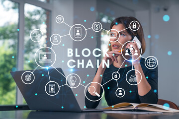 Pensive attractive beautiful businesswoman in formal wear working on laptop at office workplace in background. Using phone. Concept of business education, blockchain cryptocurrency technology.