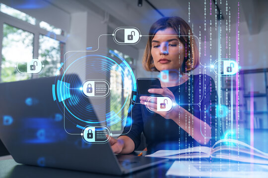 Pensive attractive beautiful businesswoman in formal wear working on laptop at office workplace in background. Using phone. Concept of business education, blockchain cryptocurrency technology.
