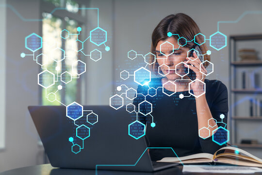 Pensive attractive beautiful businesswoman in formal wear working on laptop at office workplace in background. Using phone. Concept of business education, blockchain cryptocurrency technology.