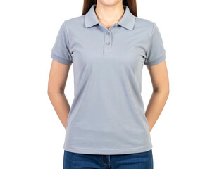 Woman in gray polo shirt and blue jeans, torso view against a dark background