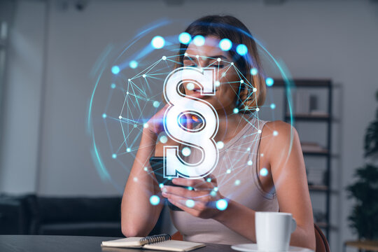 Smiling businesswoman in casual wear holding using smartphone typing at office workplace with notebook. Concept of distant work, business education. Law and legal theme icons hologram