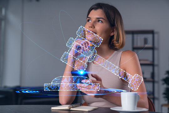 Smiling businesswoman in casual wear holding using smartphone typing at office workplace with notebook. Concept of distant work, business education. Law and legal theme icons hologram