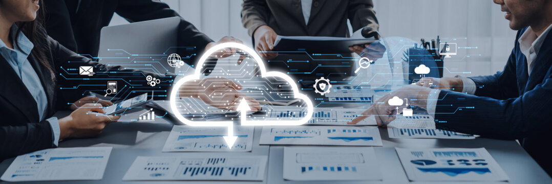 A business team collaborates in an office setting, utilizing cloud technology and data analytics for project management, showcasing innovation and teamwork. Trope