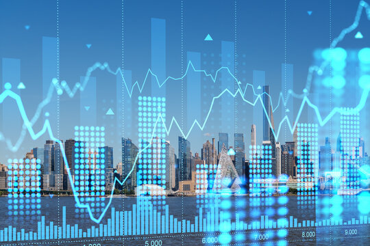 New York skyline with futuristic holographic financial graphs overlaid. Graphic design and business concept on cityscape background. Double exposure