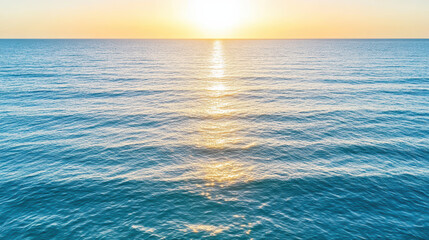 Obraz premium Serene ocean view with golden sunlight reflecting calm water surface, creating peaceful