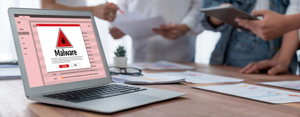 Cyber attacking concept. Malware alert showing on computer screen display scam and threat detection on computer system or online server to be removed brisk.