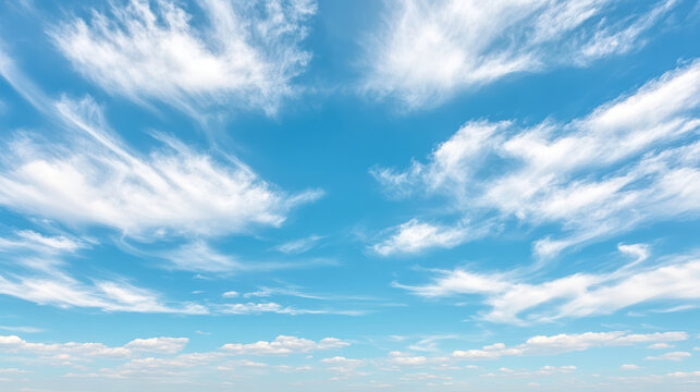 Fototapeta Bright blue sky with wispy clouds creating serene atmosphere