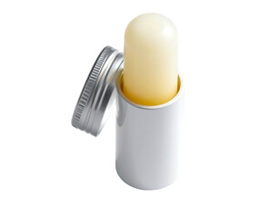 Yellow balm stick in silver container with removed cap, isolated on black background, viewed from above angle