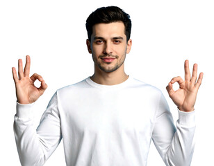 Young man smiles, presenting "OK" signs with both hands, long sleeved white shirt, on a dark background