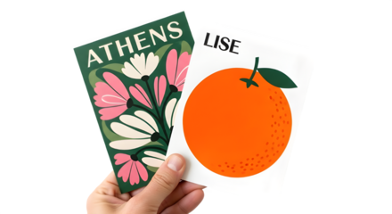 Woman holding colorful travel postcards featuring Athens design and vibrant orange fruit illustration on white.
