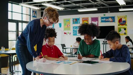 A dynamic video captures a low-angle view of a teacher engaging with diverse students in a colorful classroom, fostering creativity and learning. - Powered by Adobe