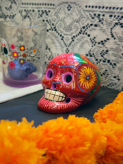 Fototapeta premium Colorful Sugar Skull With Vibrant Decorations and Marigold Flowers on an Altar for Day of the Dead Celebration